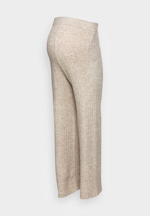 Beige, gerippte, weit geschnittene Hose mit weicher Textur, ausgestattet mit hohem Bund und minimalistischem Design ohne zusätzliche Beschläge oder Akzente.