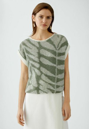 Green and white knit top with short sleeves and a relaxed fit, featuring a leaf-patterned texture and contrasting ribbed neckline.