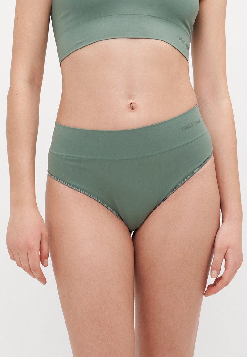 High-waisted underwear in a muted green color, made from a smooth fabric with elastic waistband, featuring subtle stitching details.