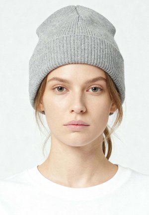 Gray knit beanie with a ribbed texture, rounded crown, and a comfortable fit, worn with a white T-shirt in a neutral background.