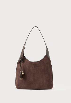 Brown suede shoulder bag with a single strap and small leather keychain accessory attached near the top left side.
