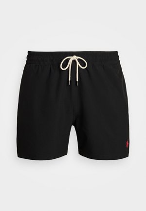 Melni peldbikses, izgatavotas no viegla auduma. Tām ir elastīgs jostasvieta ar krēmkrāsas auklu un neliels sarkans logotips uz kreisā kājas.