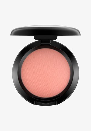 Fard à joues compact rond avec une surface en poudre lisse et rose clair. L'extérieur est noir brillant, avec une charnière pour l'ouverture et la fermeture.
