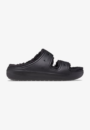 Sandalia negra tipo slip-on con punta abierta y tiras dobles recortadas, con forro suave y peludo y una suela texturizada para mejor agarre.