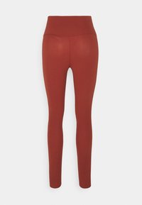 Leggings rouge rouille avec une taille haute, fabriqués en matériau extensible. Présentent une texture lisse et un design ajusté.