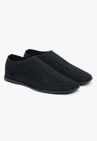 Czarne buty wsuwane z teksturowanym meshowym wzorem, z diamentowym motywem, gładkimi krawędziami i niską płaską podeszwą.