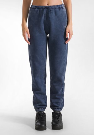 Pantaloni della tuta blu navy in tessuto morbido, con vita elasticizzata e cordino, orli affusolati e tasche laterali.
