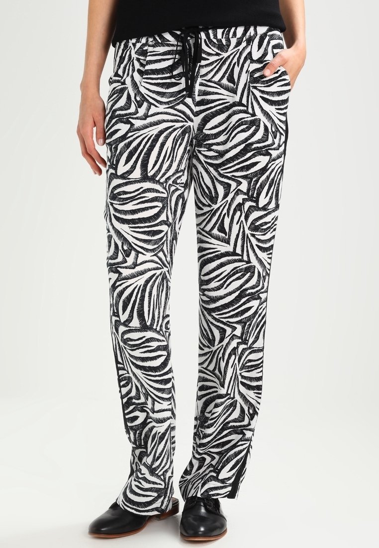 Pantalon à motifs noir et blanc avec un design de feuilles, taille à cordon de serrage et poches, fabriqué en tissu léger et respirant.
