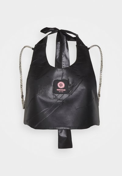 Black faux leather bag with a cut-out design, textured surface, silver chain straps, and a pink logo patch at the center.