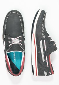 Herren Freizeitschuhe aus dunkelgrau Leder mit weißen Nähten, roten und weißen Akzenten sowie einem leichten Design mit Mesh-Seiten.