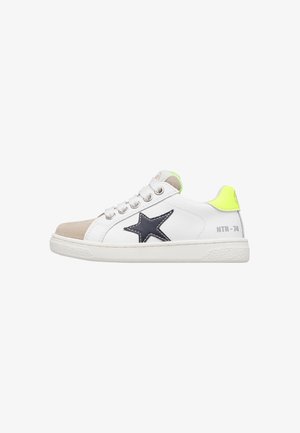 White low-top sneaker with beige toe cap, black star logo on side, neon yellow heel tab, and "HTR-74" text near sole.