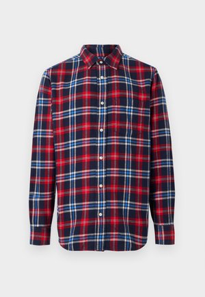 Langermet skjorte med knapper i marineblå, rød og hvit rutet mønster. Laget av flanell med klassisk krage og lomme på venstre bryst.