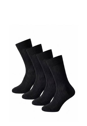 Vier Paare schwarze, gerippte Kniestrümpfe in einer Reihe auf weißem Hintergrund angeordnet.