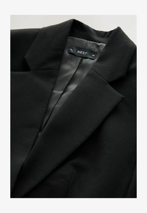 Black blazer with a notched collar, smooth fabric, and satin interior lining featuring a label branded "NEXT."