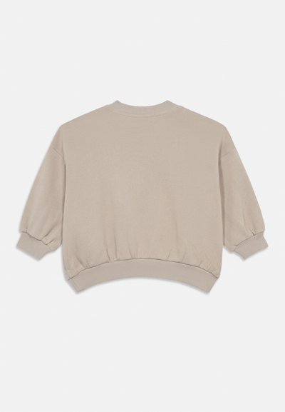 Sweatshirt cropped bege com uma bainha arredondada, mangas largas e punhos canelados. Feito de um material macio com uma textura suave.