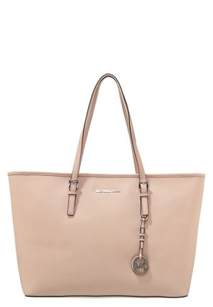 Beige Michael Kors tote bag with double shoulder straps and a hanging round MK logo charm in metallic finish.