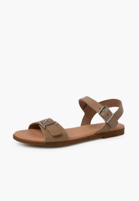 Tan leather sandal with two wide straps, silver buckle detail, and a flat sole. Features a cushioned footbed for comfort.