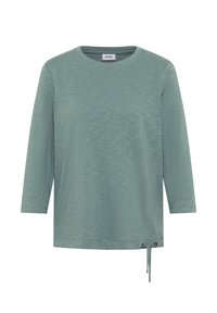 Haut à manches longues de couleur teal en tissu texturé, avec un col rond et un détail de lien latéral ajustable pour un ajustement personnalisable.