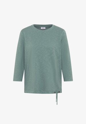 Długo rękawowy top w kolorze turkusowym, wykonany z teksturowanej tkaniny, z okrągłym dekoltem i regulowanym wiązaniem z boku, zapewniającym dopasowanie.