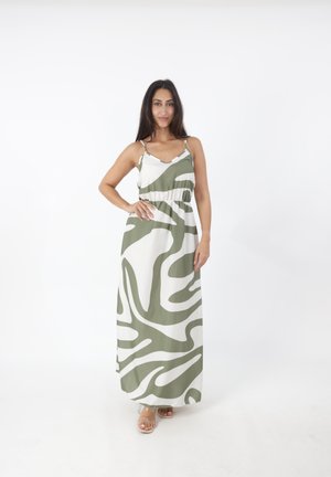 Robe maxi avec des motifs abstraits verts et blancs, bretelles spaghetti réglables, taille élastique et une silhouette fluide.