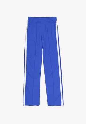 Pantalon de sport bleu en tissu doux, avec des bandes blanches sur les côtés, deux poches zippées et une ceinture structurée.