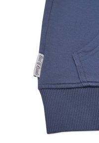 Marinblå sweatshirt med ribbade ärmslut, med en vävd etikett på sidan. Slät tygkänsla med rak passform.
