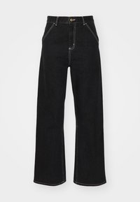 Svarte vide jeans laget av denim, med kontrasterende hvite sømmer og en frontknapplukking, samt to skrå frontlommer.