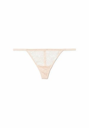 Lace thong panties in light peach, featuring thin straps and floral patterns. Soft texture with sheer sections and a seamless design.