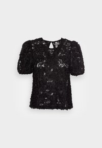 Haut noir texturé avec des manches bouffantes, présentant des motifs floraux et un dos en forme de trou de serrure. Fabriqué en dentelle avec une finition scintillante.