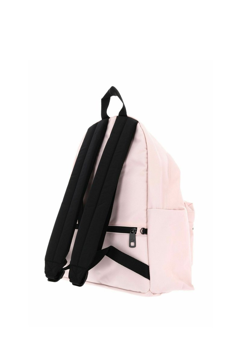 Light pink backpack with black padded shoulder straps and a small front zippered pocket, shown from back side.