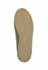 Sole of a shoe, featuring a textured pattern with a herringbone design. The color is beige with a flat, rubber construction and logo detail.