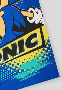 Tessuto blu con una grafica di Sonic the Hedgehog. Il design include accenti neri e gialli, motivi di schizzi e tipografia in grassetto.