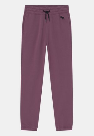 Lilla joggingbukser med elastisk linning, sort snøre, sidelommer og lille sort elglogo på højre hofte.