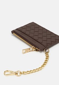 Brown woven leather wallet with gold zipper, chain attachment, and clip. Textured surface with subtle stitching detail.