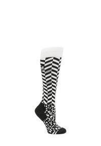 Chaussettes montantes en noir et blanc avec des rayures en zigzag en haut et un motif leopard sur le pied. Texture douce et bord élastique.