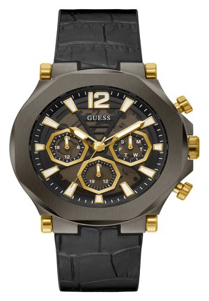 Must mustrakk kell musta nahk rihmaga, mitme kihilise halli korpusega, kuldsete aktsentidega ja musta taustaga, millel on kuue nurgaga alad ja julged tunni markerid.