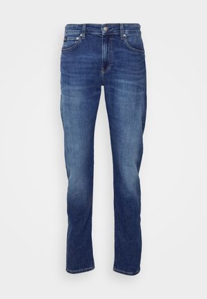 Dark blue denim jeans with a straight leg design, featuring a button closure, five pockets, and subtle fading in the fabric.