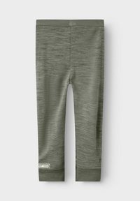 Olivgröna leggings i strukturerad tyg med en slät midjeband och en liten märkesetikett nära nederkanten. Tight passform och ankellång längd.