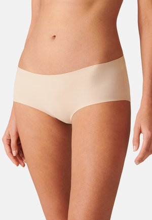 Beige hipster panties made from smooth, stretchy fabric. Features a wide, seamless waistband and no visible seams for comfort.