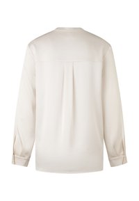 Langslavige blouse van crèmekleurige stof, met een geplooid achterpand, ronde halslijn en knopenmanchetten, met een gladde, gestructureerde oppervlakte.