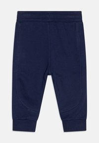 Pantaloni della tuta blu navy realizzati in tessuto morbido, con vita elastica e polsini a costine, con cuciture in contrasto per un tocco di dettaglio.