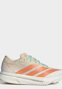 Light beige running shoe with orange stripes and light blue laces, shown from the side on a plain gray background.