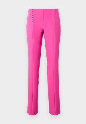 Pink fitted trousers with a smooth texture, featuring visible stitching accents and a straight leg cut.