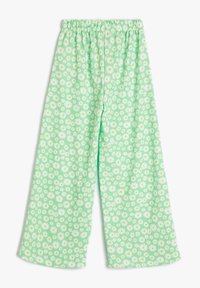 Hellgrüne weite Hosen mit einem Gänseblümchenmuster, ausgestattet mit einem elastischen Bund und einem strukturierten Stoff. Material aus Baumwollmischung.