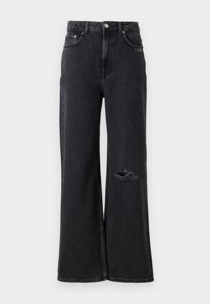 Jeans negri din denim cu picioare largi și talie înaltă, prezentând o ruptură distrusă la genunchiul stâng și accesorii clasice din metal, cum ar fi nasturele și nituri.