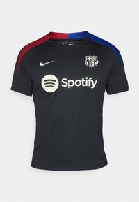 Sort Nike fodboldtrøje med røde og blå skulderaccenter, rund halsudskæring og Spotify-logoet centreret på forsiden.