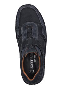 Dark gray shoe with a mix of smooth leather and textured mesh. Features a stitched design, elastic strap, and a contrasting brown interior.