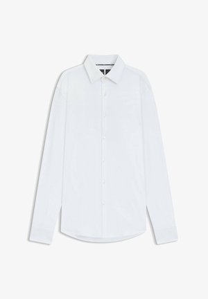 White long-sleeve shirt with a classic collar, button front, and a curved hem. Made from smooth fabric with subtle texture throughout.