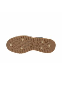Suela de zapato de goma con un patrón texturizado, que presenta agarres circulares y triangulares en relieve. Color: marrón claro con acentos más oscuros.