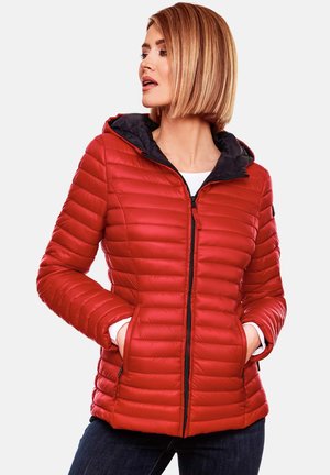 Red padded jacket with a black hood, quilted texture, front zip closure, and side pockets, paired with dark jeans.